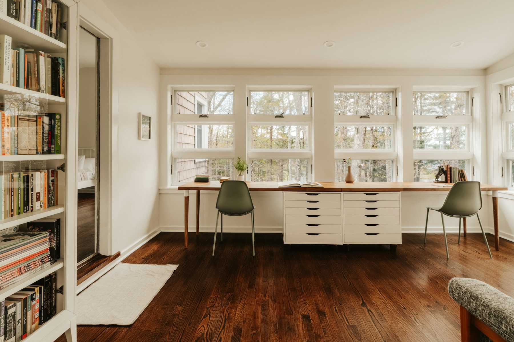 Bright, naturally lit office workspace with desks by large windows